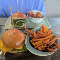 Vegan 'chicken' truffle burger with sweet potato fries. Vegan 'beef' and mushroom burger with cauliflower wings. at Hans im Glück in Koblenz