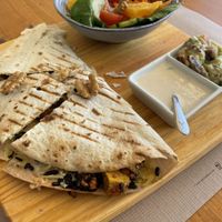 Vegan quesadilla, accompanied by a salad, guac and vegan “sour cream”  at Earth Shop and Cafe in Carvoeiro