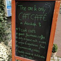 Sidewalk sign in front of cafe. at Milou in Aachen