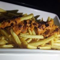 fries topped with vegan cheese at Mooo in Recife