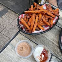 Sweet potato fries with vegan chipotle aioli, and vegan sour cream with I think sweet chili sauce   at The Hold in Manly