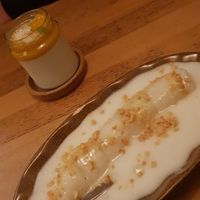 Desserts: Mango in sticky rice with coconut sauce and peanut sprinkles. Rear: Another mango and coconut dessert, also delicious. at Hum Vegan Cuisine in Berlin