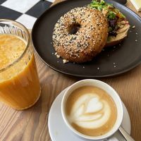 Vegan bagel with hummus and beetroot, fresh orange juice, cappuccino   at Kawiarnia Stragan in Poznan