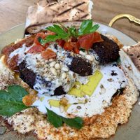 Tahini sauce on top of hummus and falafel   at Mezze Bar in Auckland