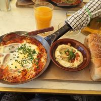Shakshuka served with hummus at Shuk in Warsaw