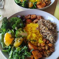Quinoa, rice, broccoli, kale, lettuce, sweet potato, tofu, spiced chickpeas, and orange. Great bowl of goodness. at Cardamomo in Bogota