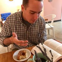 enjoying an espresso cream donut and drip coffee in the lobby area behind Holey Rollers at Holey Rollers Bakery in Oklahoma City