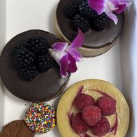 Vegan cheesecakes, sprinkle cookie dough truffle, and chocolate truffle  at Sinners & Saints Desserts in Venice