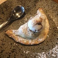 Vegan dessert calzone, filled with bananas, pecans and blueberries, topped with coconut & chocolate ripple ice cream at Zizzi - Bankside in South East London