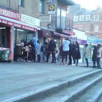 Sunday morning worshipers waiting in line. at Temple of Seitan - Hackney in East London