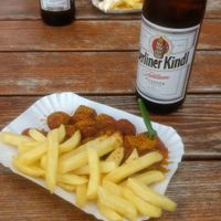 Vegan currywurst and chips (in the background meat currywurst and chips)  at Curry at the Wall - Food Stand in Berlin