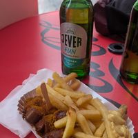 Menu with Currywurst fries and drink at Curry at the Wall - Food Stand in Berlin