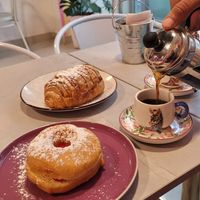 filled donut with whipped cream and jam & Coffee at Frambuesa Pastelería Vegan in Bogota