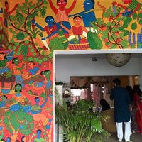 Beautiful space with lots of art and varied seating (tables, floor cushions). at Jatra Biroti in Dhaka