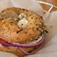 Toasted Whole Wheat Italian Seasonings Bagel with Tofutti (R), Tomato, Red Onion, and Sprouts at Bagel Cafe in Camden