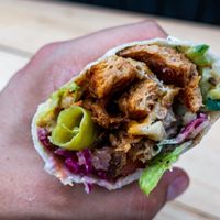 Vegan Döner
Freshly Made Bread, Spiced Soya Pieces, Mixed Salad, Tzatziki (Soya yogurt), Homemade Hummus and Chilli Sauce.  at What The Pitta in London