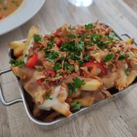 Chips with gravy, 'cheese' and crispy onion (poutine) at The Cornish Vegan in Truro