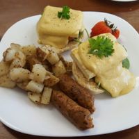 Tofu eggs benny on homemade biscuit, with a side of sausages. at Grow Your Roots Cafe in Ottawa