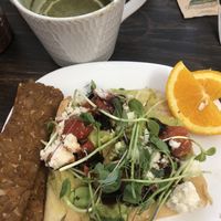 Brunch - avocado toast on focaccia bread with side order of tempeh bacon  at Grow Your Roots Cafe in Ottawa