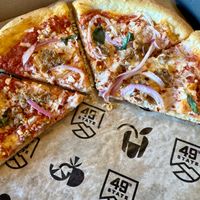 Half eaten spicy sausage pizza - YUM!  at 49th State Brewing Co in Anchorage