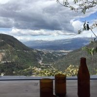 Gorgeous view from restaurant seats.  "Cerveza artisanal" and recycled glasses on top of the table made out of reclaimed/recycled wood.  Incredible location! at Tandana in Quito