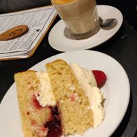 Almond and raspberry cake, with a chai latte.  at The Canvas: Shoreditch in East London