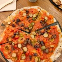 Pizza with vegan anchovies, olives and tiny cucumbers at #RAW VEGAN FIRENZE in Florence