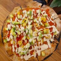 Pizza with avocado and vegan cheese on it from cashew at #RAW VEGAN FIRENZE in Florence