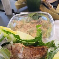 Raw burger. Not dehydrated. Cesar salad in the back. at True Earth Juicery & Vegan Cafe in North Hollywood