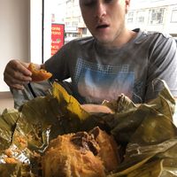 Adam eating a giant sized tamale  at La Campoteca in Bogota