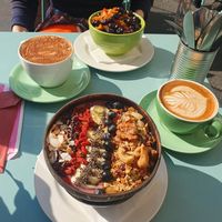 Acai bowl and apple crumble porridge with extra blue berries. Chai latte and cinnamon latte at Hula Juice Cafe in Edinburgh