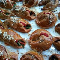 Pizza-Brioche from Vegi in Santa Eulalia, Ibiza. Filled with vegetables and vegan cheese. Some vegetarian options with goat cheese and/or mozzarella. This is NOT like empanadas. It's brioche bread with pizza flavour. Speciality you only find at Vegi. at Vegi in Ibiza