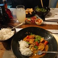 Yasai Samla Curry - a fragrant, spicy lemongrass and coconut curry with tofu, peppers, shiitake mushrooms and tomatoes. with white rice, topped with spring onions and chilli. at Wagamama in Norwich