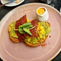 Avo smash, tofu scramble, and vegan bacon with sriracha cashew mayo all on toasted sourdough at Rose & Grant's in Glasgow