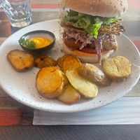 Mockme burger (chickun and rice paper bacon) with a side of cheesy sauce  at Particle Cafe in Avondale Heights