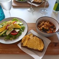 Salad, toast with pumpkin spread, chickpea and Spinach dish at Natu in Santander