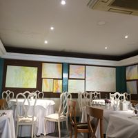 General view of restaurant. Some tables have fabric table clothes and others are paper table clothes. Dated decoration.  at Natu in Santander
