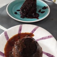 Chocolate cake with berry sauce and chocolate pudding. at Natu in Santander