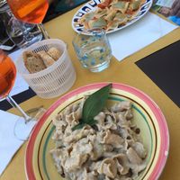 Pasta with creamy walnut sauce, fresh pea stuffed ravioli with tomato sauce. at In Pasta in Lucca