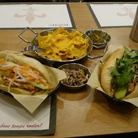 Regular bahn mi sandwich (left), nacho with cheese (top), Buddhist vegetarian bahn mi sandwich (right), a little gift from the chef (center). at Lagniappe in Seongnam