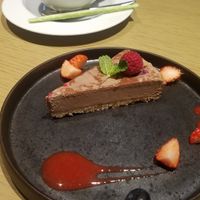 Raspberry cacao raw cake and soy latte  at Cosme Kitchen Adaptation - Atre West in Tokyo