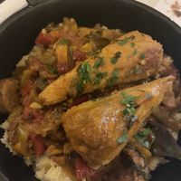 “Chicken legs” over couscous  at Delice & Sarrasin in New York City