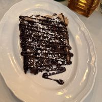 Oat milk, chocolate cake with too much chocolate on top  at Delice & Sarrasin in New York City