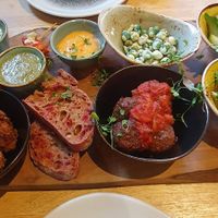 Sharing Platter - Marinated tofu with garlic & cucumber sauce, cauliflower
popcorn, tomato & oregano plantballs, soup of the day,
tabbouleh, grilled vegetables, olives, sriracha ma at The Allotment in Manchester