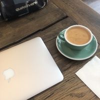 Enjoying a flat white latte   at Nuage Cafe in Paris