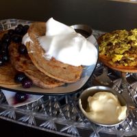 Pancakes with blueberries and aquafaba whipped cream; breakfast  pizza at The Breakfast Club in Lawrence