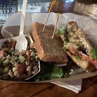 Vegan artichoke fish filet sandwich on rye bread with a side of black eyed pea saladd  at Smithtown Seafood in Lexington
