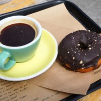Café allongé + vegan chocolate donut at Shakespeare and Company Cafe in Paris