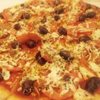 Specifically named vegan pizza, has olives, oregano, fresh tomato and vegan cheese at Allambie Pizza Shop in Allambie Heights