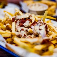 CHEESY BACON FRIES -
Loaded Shoestring Fries with Cheese Sauce and Plant-based Bacon bits. at Soul Burger in Glebe